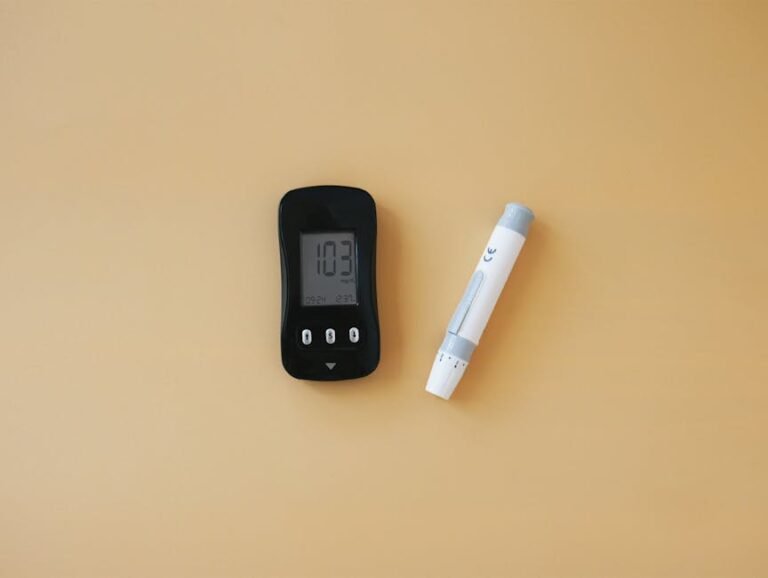 Close-up of a glucose meter and lancet pen, essential for diabetes management.