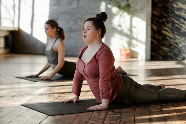 Women practicing yoga indoors, focusing on wellness and inclusion.