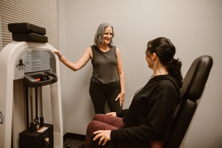Two women exercising with gym equipment, promoting fitness and wellness indoors.
