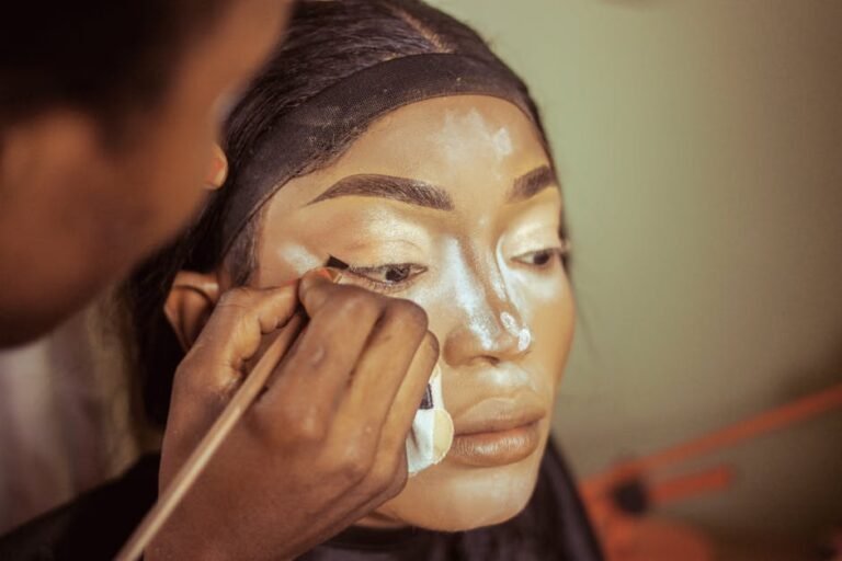 Close-up of makeup being professionally applied, highlighting skillful technique.