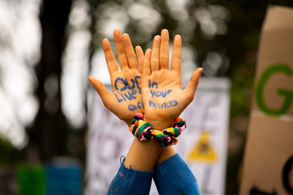 Hands with activist message during a protest in Dublin, Ireland, emphasizing change.