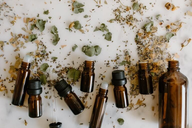 Flat lay of brown glass bottles and dried herbs, perfect for aromatherapy themes.
