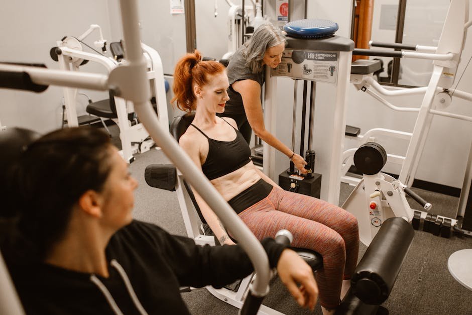 Women working out on gym equipment, promoting strength and fitness.