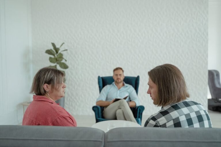 Image of a counseling session with a professional advisor, focusing on a couple's discussion.