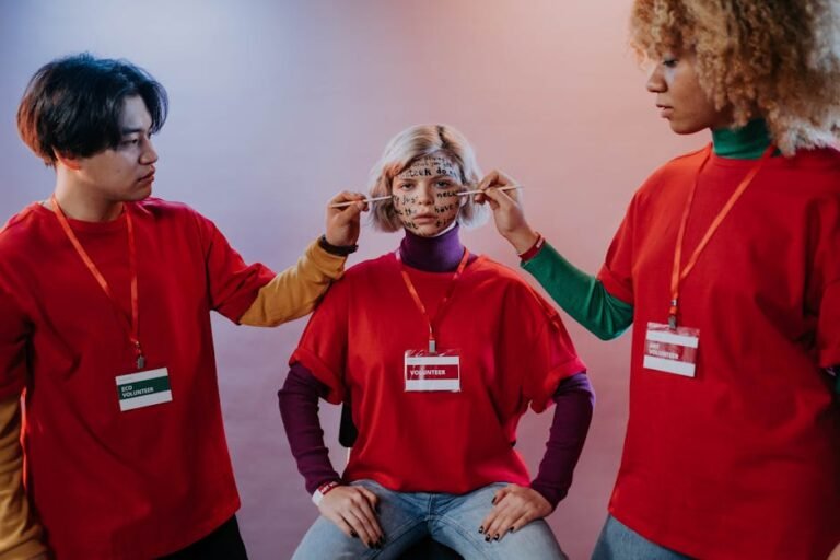 Volunteers share encouraging words by painting them on a face, promoting team spirit.